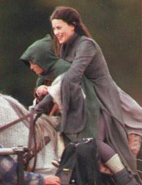 Liv Tyler holds Frodo on horseback.