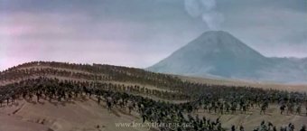 Thousands of orcs march through Mordor, with Mt. Doom smoking in the background.