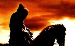 A Black Rider silhouetted by a setting sun.